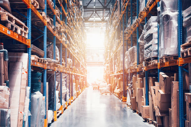 istock Large distribution warehouse with high shelves, many goods and boxes with abstract light 1224353521