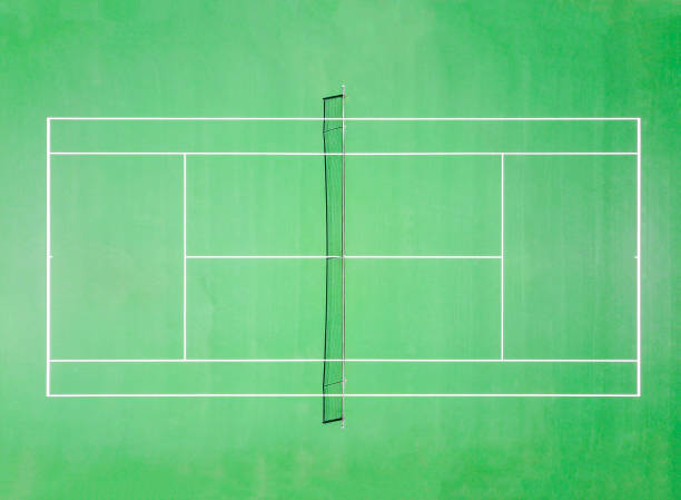 Top view of green tennis court in summer Sunny day Top view of a green tennis court on a summer sunny day baseline stock pictures, royalty-free photos & images