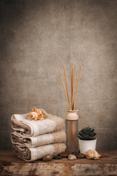 istock Spa essentials, aroma sticks, stones, towels, sea shell on a wooden rustic background 1224354917