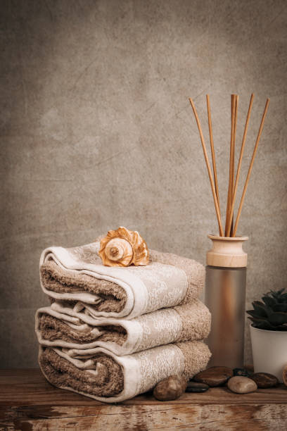 istock Spa essentials, aroma sticks, stones, towels, sea shell on a wooden rustic background 1224355442