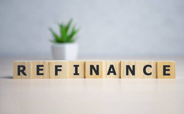istock focus on wooden blocks with letters making Refinance text. 1224355886