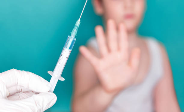 istock Hand of afraid boy showing stop. Vaccination concept, prevention 1224355920