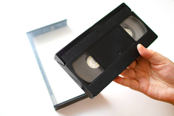 istock Woman holding videotape in hand. 1224356176