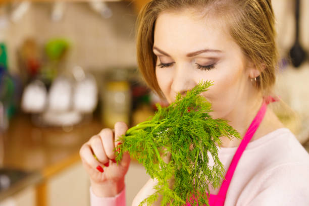 istock Young woman holding dill herb 1224358631