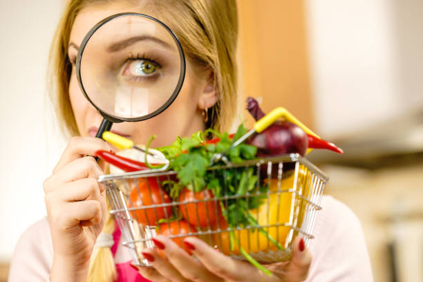 istock Woman investigating shopping backet with vegetables 1224358827