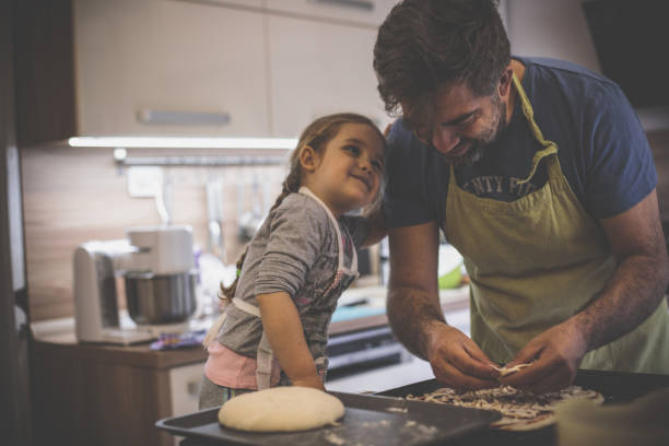 istock Little sous chef checking father making a pizza 1224359052