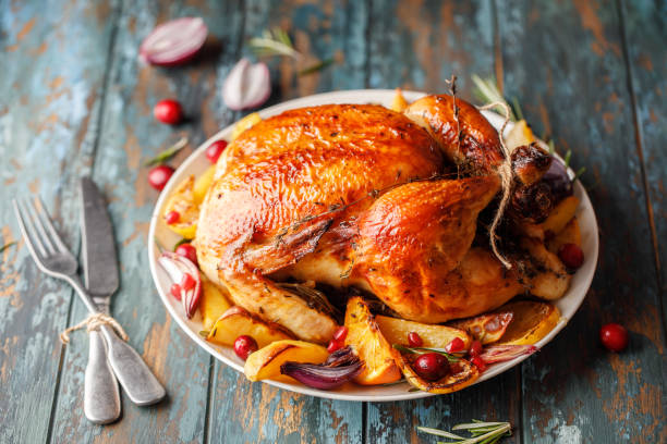 istock Roast whole chicken with roast vegetables on plate on a table 1224361273