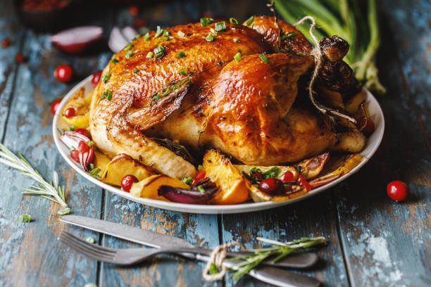 istock Roast whole chicken with roast vegetables on plate on a table 1224361376
