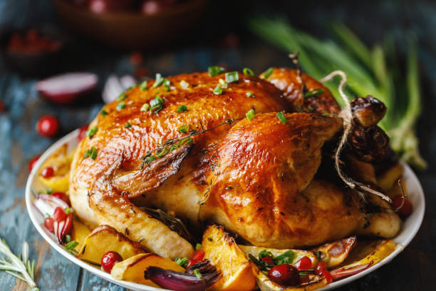 istock Roast whole chicken with roast vegetables on plate on a table 1224362235