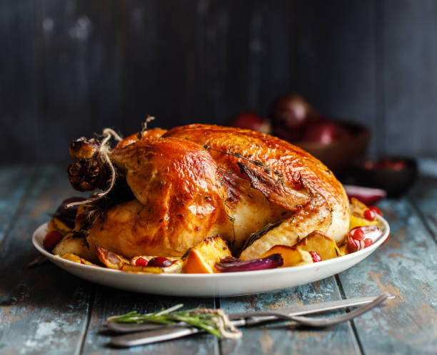 istock Roast whole chicken with roast vegetables on plate on a table 1224362280