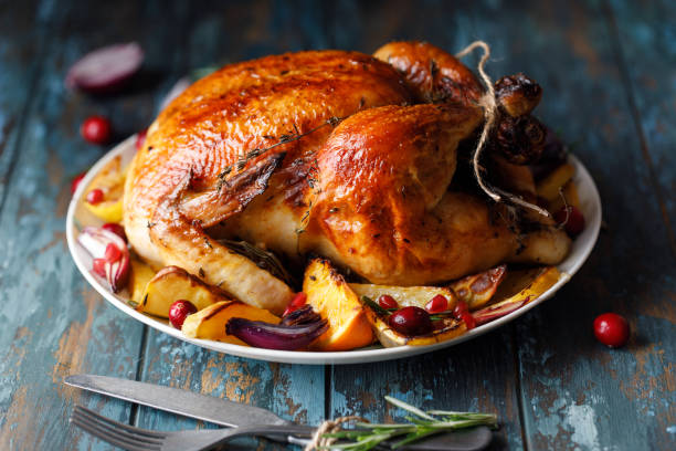 istock Roast whole chicken with roast vegetables on plate on a table 1224362320