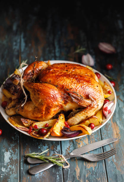 istock Roast whole chicken with roast vegetables on plate on a table 1224362394