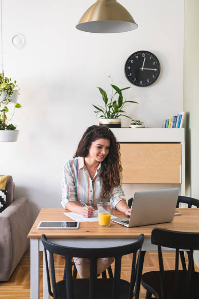 istock Woman working on laptop computer from home stock photo 1224365437