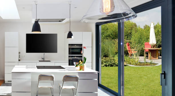 istock Open modern kitchen from loft with view on a lush garden 1224365788
