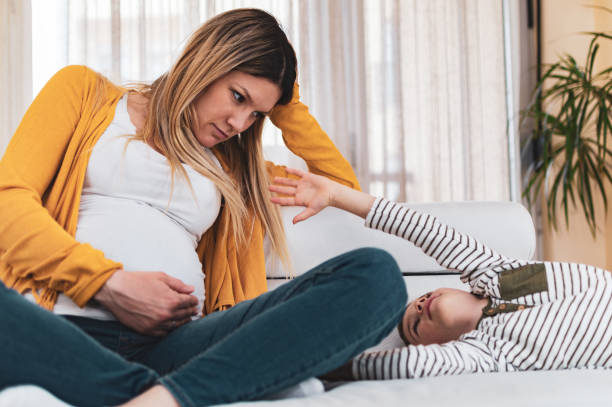 istock Jealous little boy with his pregnant mother 1224366363