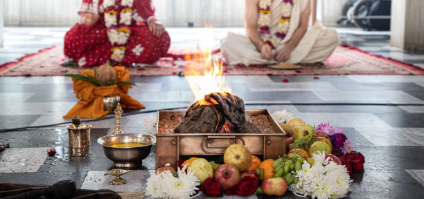 istock hindu bride and groom sit opposite fire during Indian Yajna ritual. authentic Vedic fire ceremony called Pooja. Indian tradition. Hindu wedding vivah Yagya. 1224366683