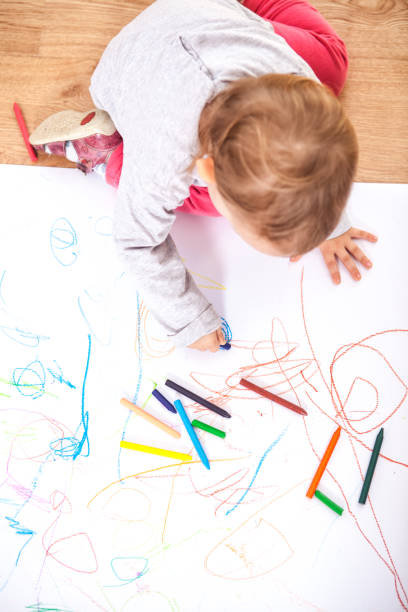 istock Little baby girl drawing 1224369263