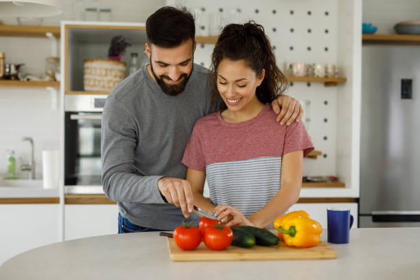 istock Affectionate couple preparing salad in a domestic kitchen 1224373183
