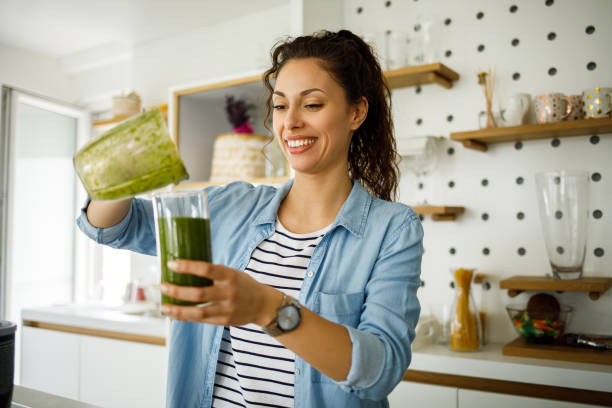 istock Young woman preparing a green smoothie at home 1224373241