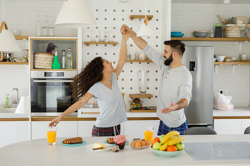 Happy romantic couple dancing in the kitchen
