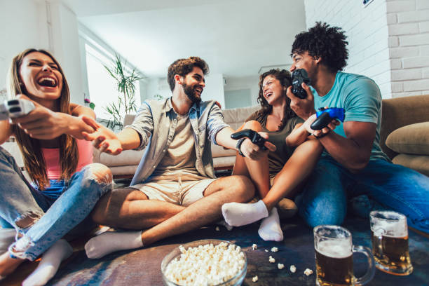 istock Group of friends having fun playing video games at home. 1224374880