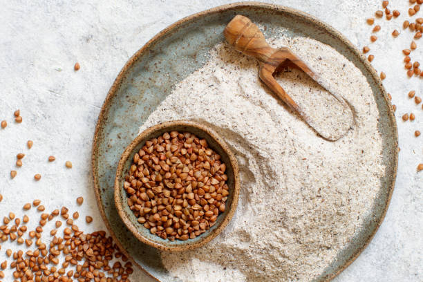 istock Buckwheat flour in a bowl and buckwheat grain, Alternative flour 1224376119