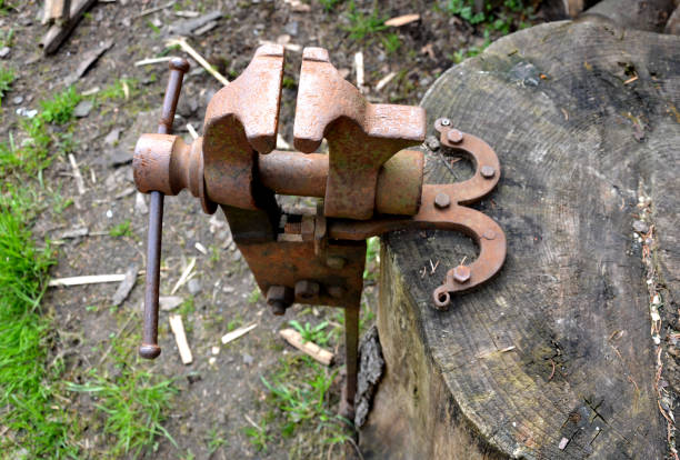istock A rusty vice located outside on a stump is used to grip objects for work, also to sharpen a hand scythe. 1224376848