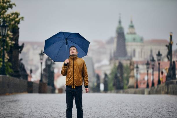 istock Man with umbrella in heavy rain 1224378533