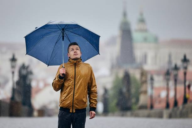 istock Man with umbrella in heavy rain 1224378551