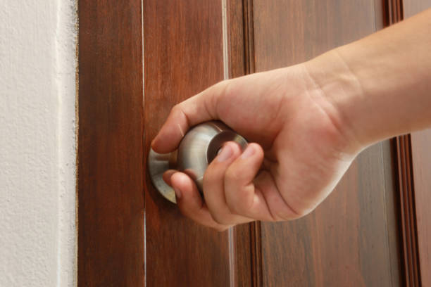 istock man use hand is opening the door. 1224379888