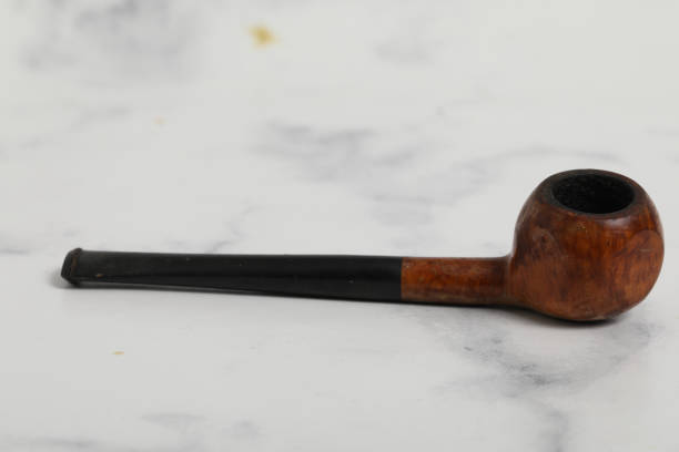 istock Pipe made of wood snuff smoking on white marble background 1224380110