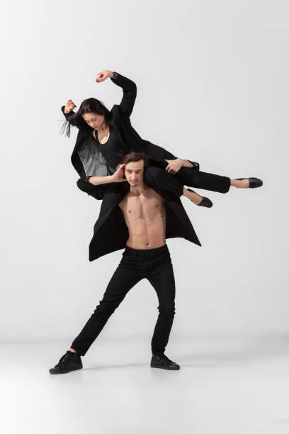 istock Young and graceful ballet dancers in minimal black style isolated on white studio background 1224382632