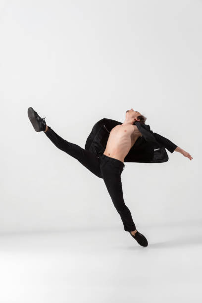 istock Young and graceful ballet dancer in minimal black style isolated on white studio background 1224382643