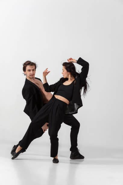 istock Young and graceful ballet dancers in minimal black style isolated on white studio background 1224382647