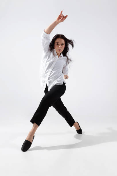 istock Young and graceful ballet dancer in minimal black style isolated on white studio background 1224382692