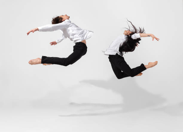 istock Young and graceful ballet dancers in minimal black style isolated on white studio background 1224382740