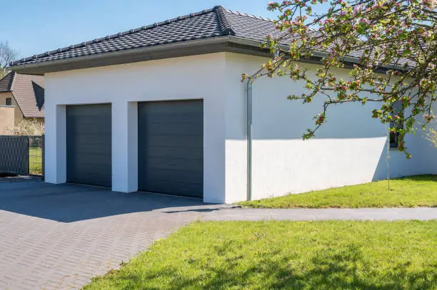 Photo of Modern and luxurious double garage with driveway and roller door