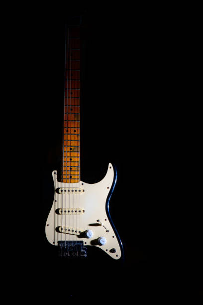 istock Electric guitar on a black background between light or shadows 1224383923