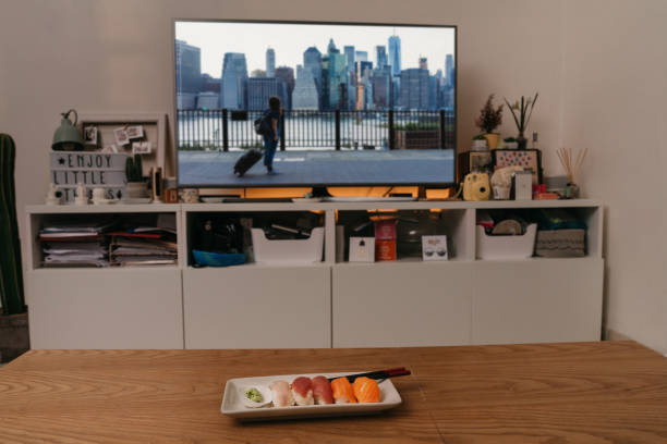 istock Sushi dinner in front of TV 1224385070
