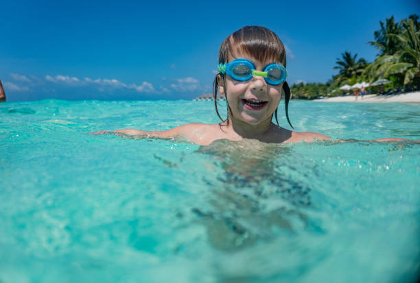 istock Boy with swimming goggles in the sea 1224386784