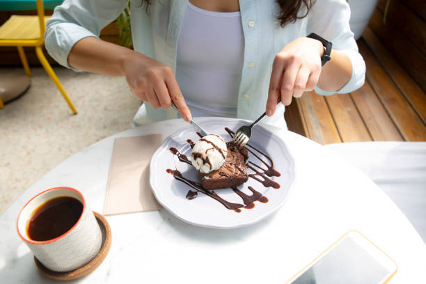 istock Woman eating cake in cafe 1224387210