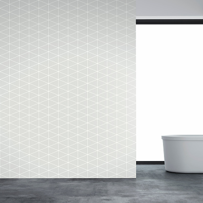 Bathroom interior on gray concrete floor and empty gray and white geometric pattern wallpaper background with copy space. Self-standing bathtub on the right and windows in background. 3D rendered image.
