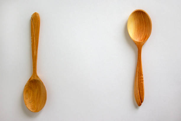 istock Two beautiful wooden spoons isolated on white background. 1224387403