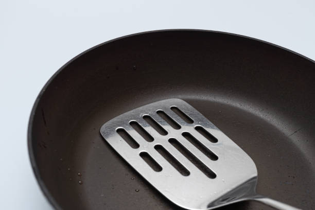 istock Old oily frying pan and utility turner 1224389961