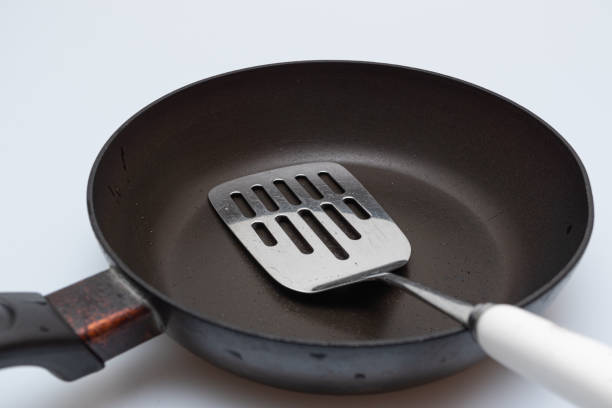 istock Old oily frying pan and utility turner 1224389991