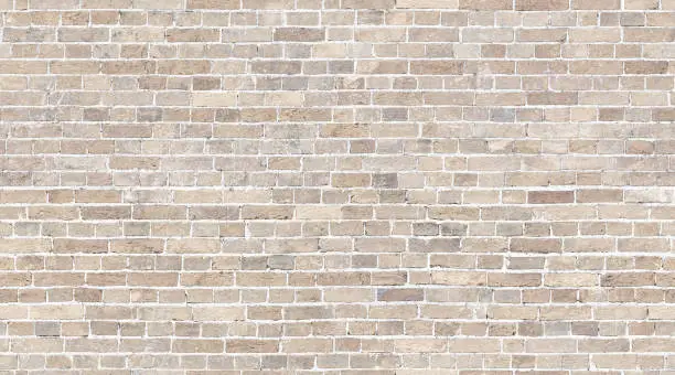 Photo of Brick wall seamless texture. Beige stone pattern background