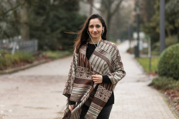 istock Female Model Posing in Poncho Outdoors 1224392627