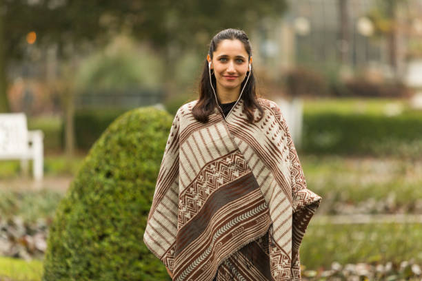 real life female model in poncho posing outdoors - real people beautiful outdoors selective focus imagens e fotografias de stock