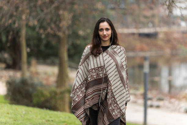 istock Young Middle Eastern Woman Wearing Poncho Modeling Outdoors 1224392776