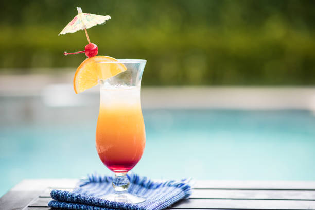 a summer drink by the pool a tequila sunrise drink by a pool tequila sunrise stock pictures, royalty-free photos & images